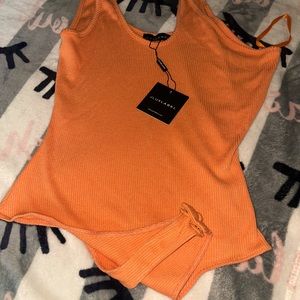 Orange body suit with button closure. High quality knit fabric. Great stretch.